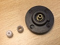 a gear before and and one after drilling it to fit the bushing