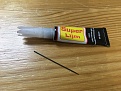 Super glue and a needle to transfer it to the axle
