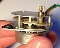 The removed motor with the damaged gear clearly visible.