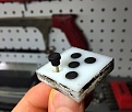 Drilled a 1/16" hole into the back to help pop out the feet without damaging them.